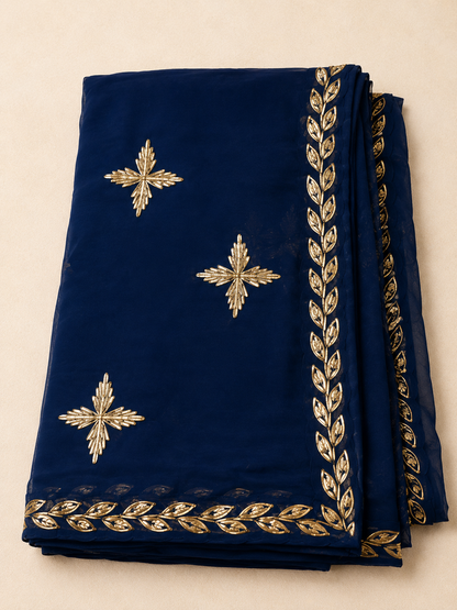 Navy blue chiffon darwari saree - folded flat lay showing gold gota patti butis and leaf border