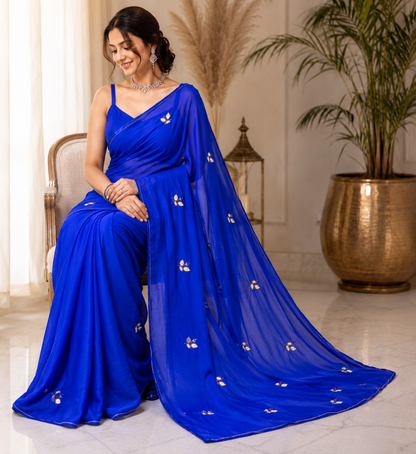 Najbeen royal blue chiffon darwari saree – model sitting view with gold shimmer border detail