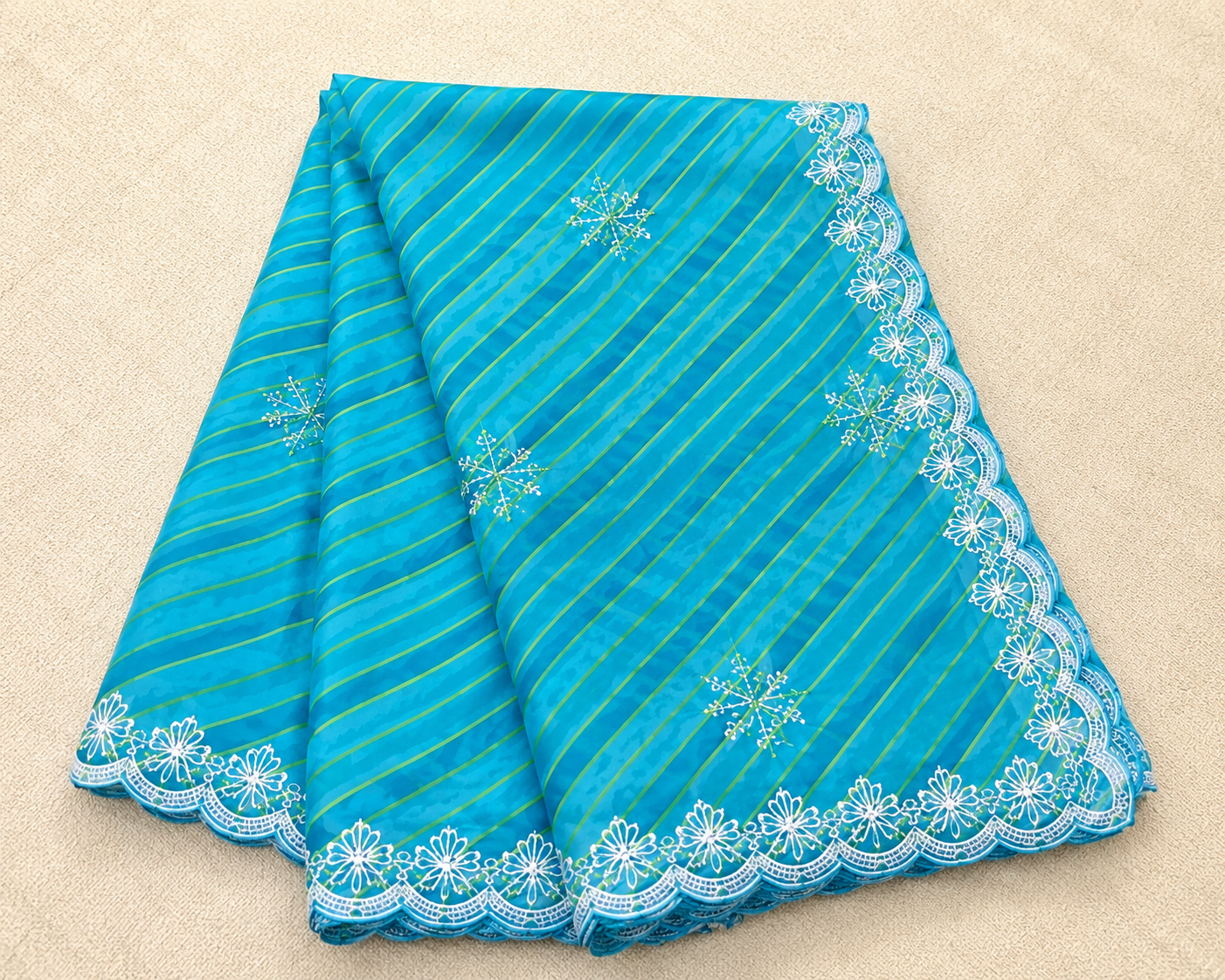 Sky blue lehariya georgette saree – folded view showing diagonal lehariya stripes and white lace border